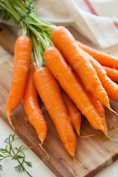 Preview: raw carrot vegetable on wooden chopping board