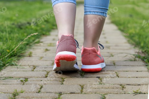 Preview: Female feet in sneakers back view closeup outdoors