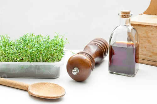 Fresh Greens and Wooden Kitchenware on White Table