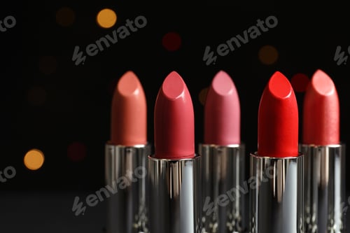Preview: Different lipsticks against blurred lights. Cosmetic product