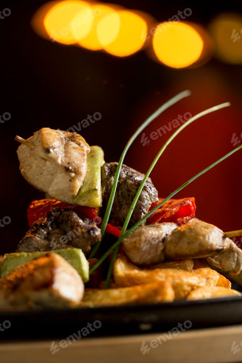 Preview: Chicken, pork and beef meat skewers with vegetables and spicy potatoes