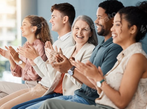 Preview: Group of cheerful businesspeople clapping while sitting in a row in a meeting together. Joyful busi
