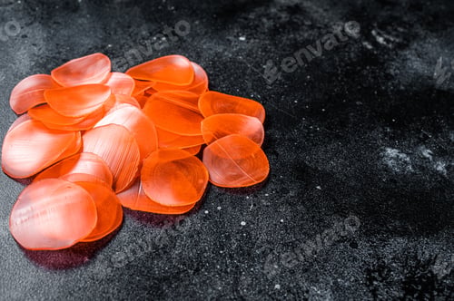 Preview: Raw kerupuk or prawn shrimp crackers, chips. Black background. Top view. Copy space