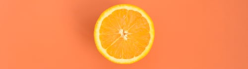 Preview: Top view of a one orange fruit slice on bright background in orange color. A saturated citrus