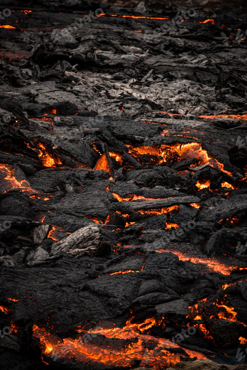 Preview: Mesmerizing vertical shot of lava flowing over the bumpy mountain