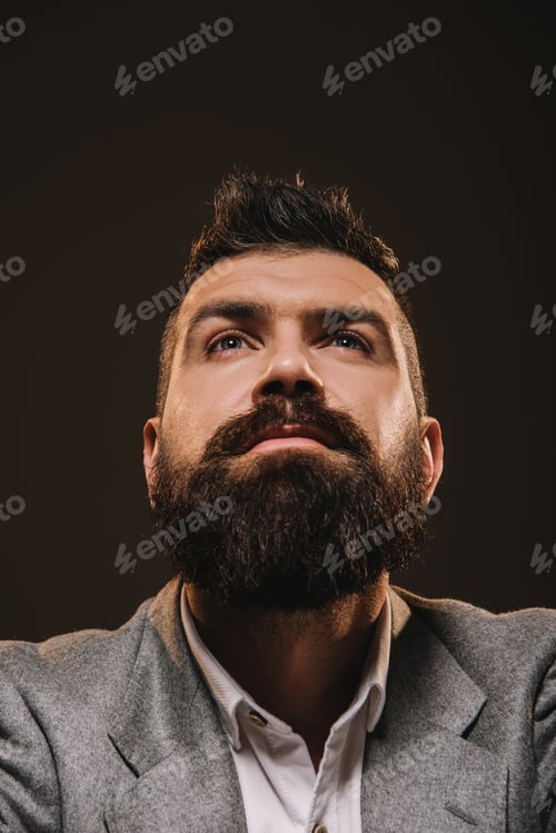 Preview: handsome beard thoughtful businessman isolated on brown