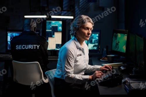 Preview: Middle Aged Caucasian Woman Monitoring Surveillance Footage in Security Office