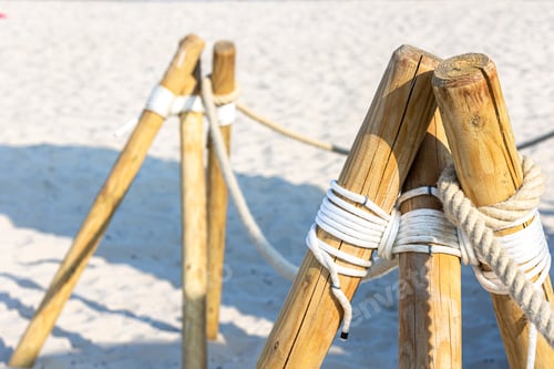 Preview: Close-up, wooden posts on the sandy beach.
