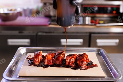 Preview: Before baking, the chef pours sauce or marinade over the pork ribs.