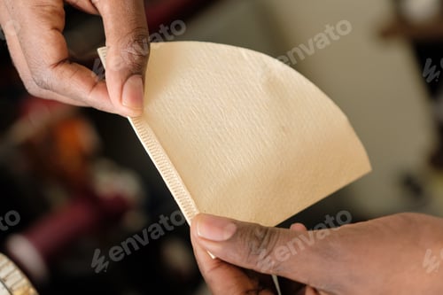 Preview: Hands Holding Beige Coffee Filter in Natural Light