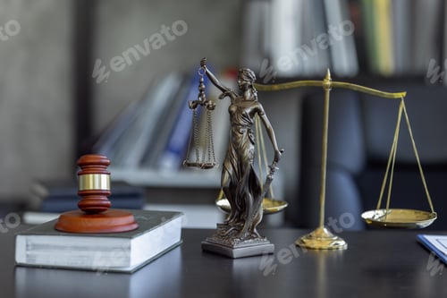 Preview: Statue of Justice and female lawyer in suit at workplace with laptop, gavel and femida in office.