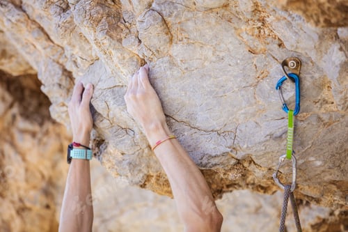 Preview: Closeup of climber's hands on cliff