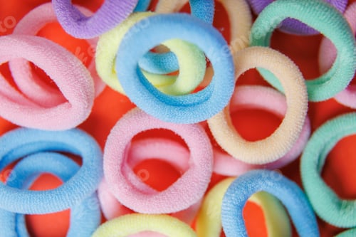Preview: vibrant close up of a rubber bands on the red background