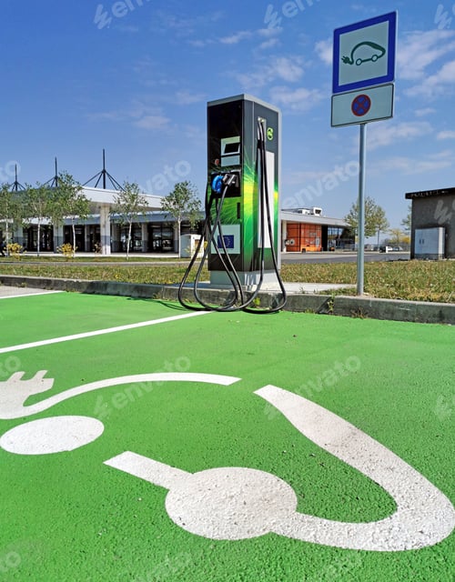 Preview: EV charging station on parking lot. Green parking spot for electric vehicles.