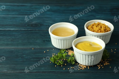 Preview: Bowls with sauces on wooden table, space for text