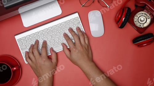 Preview: Overhead view man hands typing on wireless keyboard.