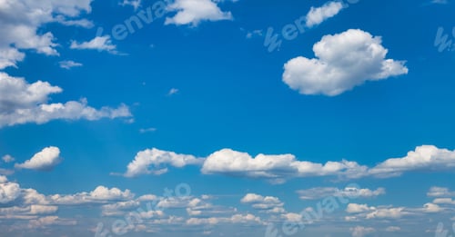 Preview: Panorama of blue sky with white fluffy clouds, atmospheric sunlight backdrop