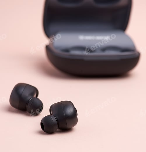 Preview: Black wireless little earphones and a charging box