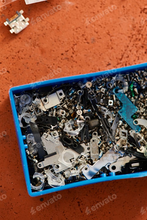 Preview: top view of plastic box with different spare parts in professional repair shop, small business