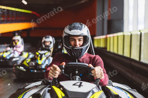 Preview: young man kart driver looking at camera