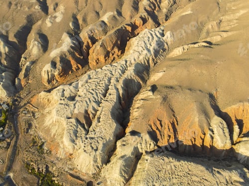 Preview: Aerial texture of light and dark eroded arid mountain landscape