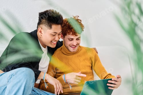 Preview: Man pointing the laptop screen next to his gay couple