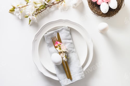 Preview: Easter table setting with blooming apple flowers on white table.
