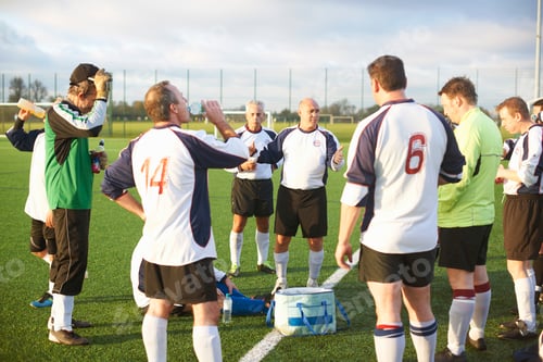 Preview: Football players resting and hydrating at half time