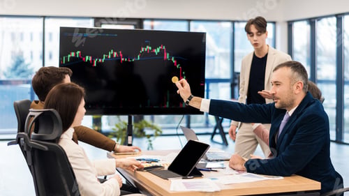 Preview: Young worker leading business meeting about cryptocurrencies in an office