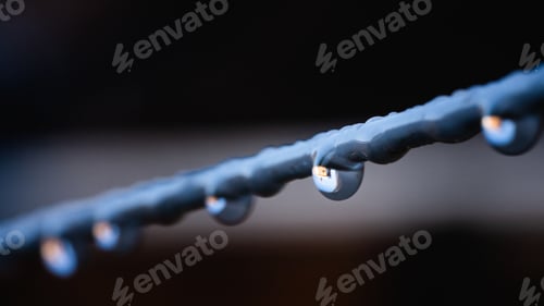 Preview: Closeup shot of water droplets on a steel wire