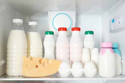 Preview: Open refrigerator with many different products, closeup