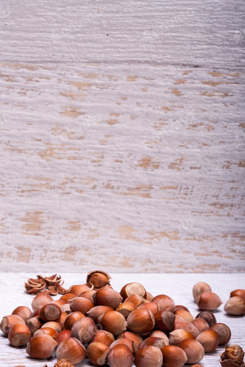 Preview: Healthy Hazelnuts on white wooden background
