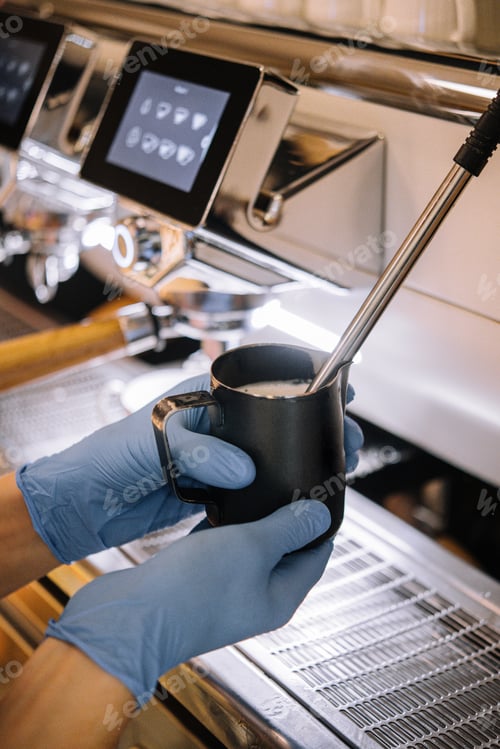 Preview: Barista making milk foam in the metal cup