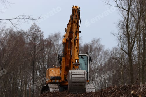 Preview: Closeup of an excavator in a forest during daylight