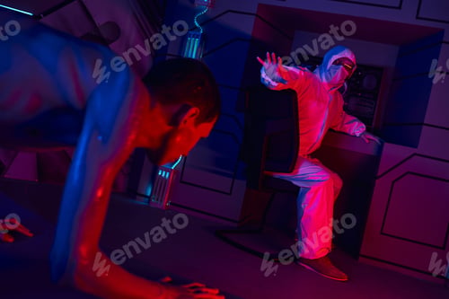 Preview: extraterrestrial humanoid crawling near scientist in hazmat suit showing stop gesture in lab