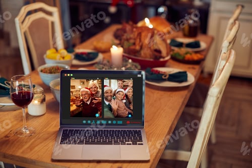 Preview: Happy extended family greeting each other on Christmas Eve via video call.