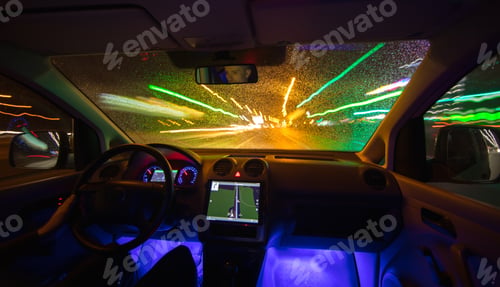 Preview: The man drive car in the rainy city. Evening night time