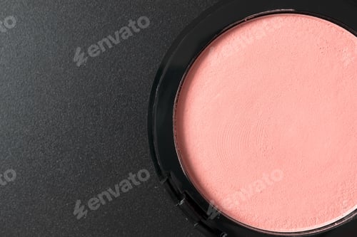 Preview: Compact pink blush on black background with copy space, close up