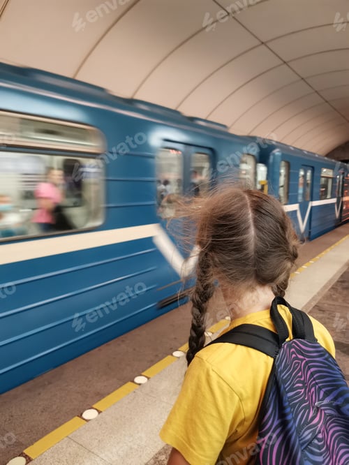 Preview: teenage girl in subway on background of train. motion blur