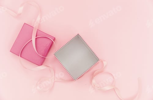 Preview: Girl birthday present concept. Gift box open and empty on pink background.