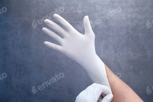 Preview: man doctor wears medical latex gloves, close up