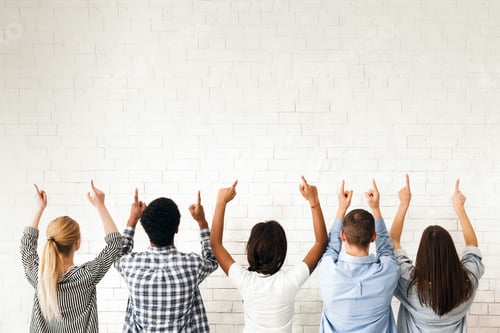 Preview: Group of Diverse Teenagers Pointing Upwards at Blank White Wall