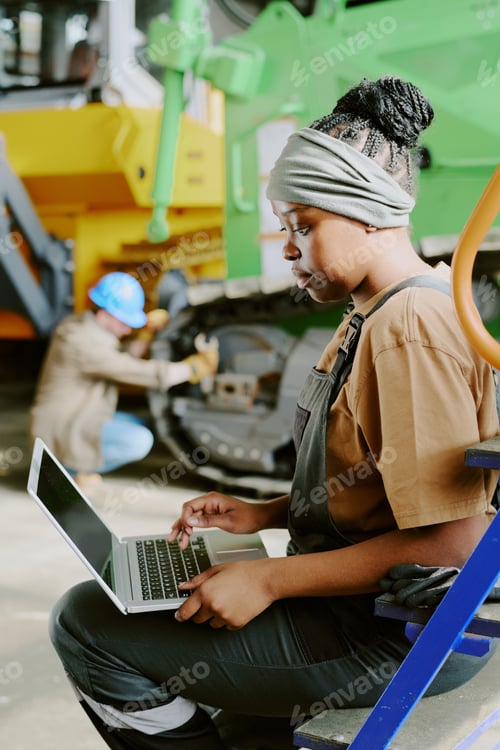 Preview: Young Black Female Factory Worker Using Laptop