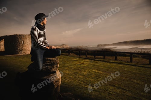 Preview: Woman and sitting on bench on shore near water