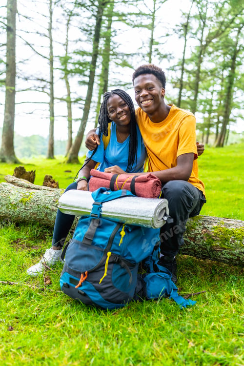 Preview: African couple embracing sitting in the forest