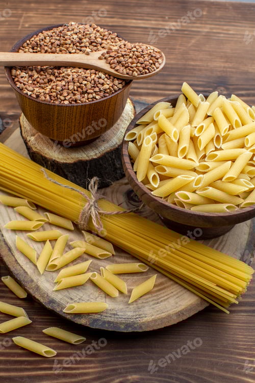 Preview: front view raw pasta with buckwheat and seasonings on brown background spaghetti meal cereal