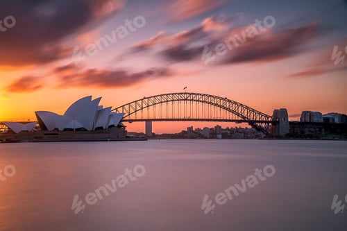 Preview: Beautiful shot of the Sydney harbor bridge with a light pink and blue sky in background at sunset