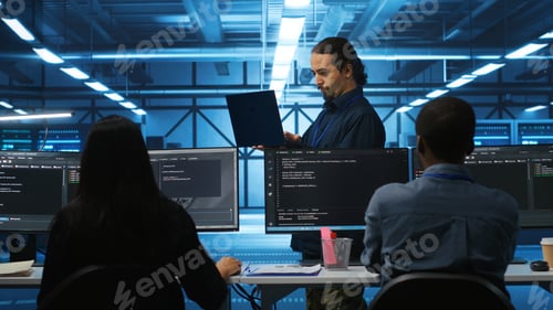 Preview: Manager reading paperwork on laptop, verifying infrastructure documents