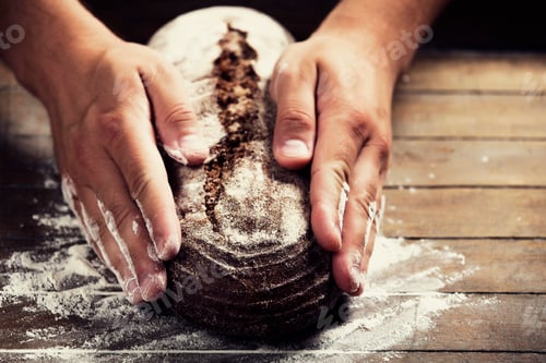 Preview: Baker's hands with a bread