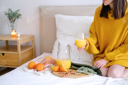 Preview: Woman Enjoying Fresh Orange Juice in Bed